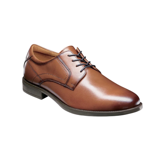 Brown leather dress shoe on a white background