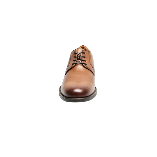 Brown leather dress shoe on a white background
