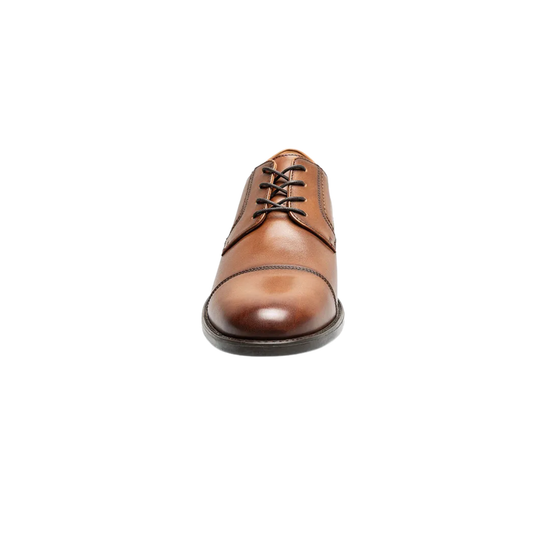 Brown leather dress shoe on a white background