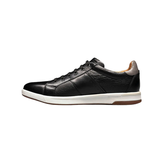 Black leather sneaker with white sole on a white background