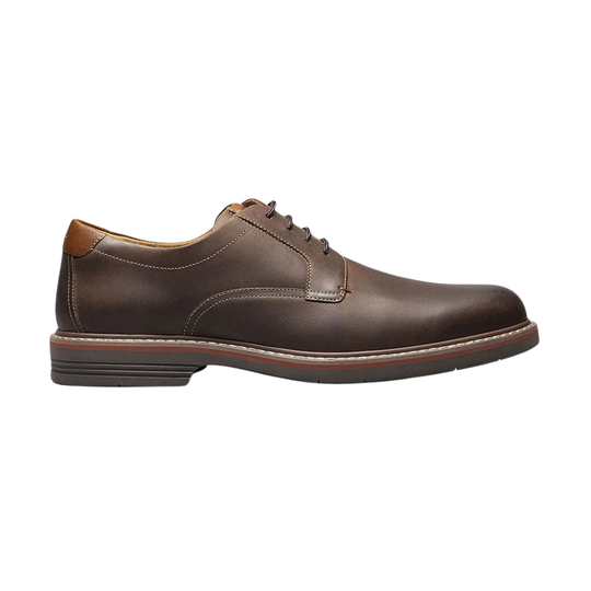 Brown leather dress shoe on a white background
