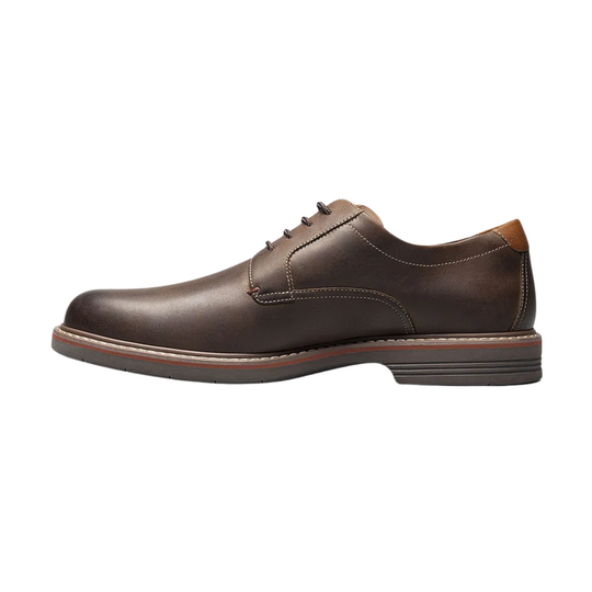 Brown leather dress shoe on a white background
