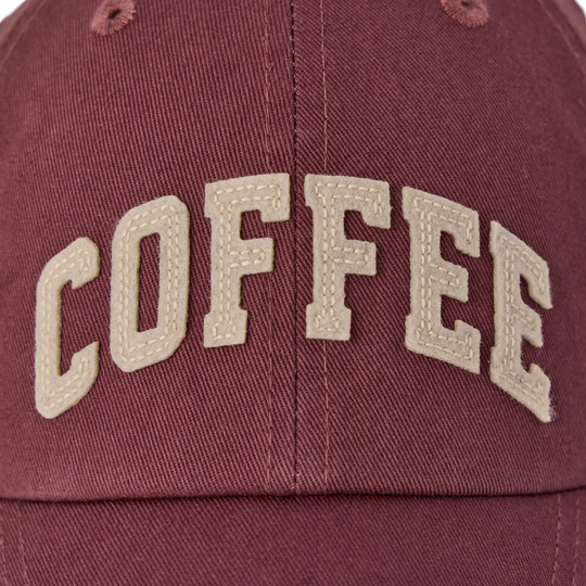 Maroon cap with 'COFFEE' embroidered in beige on a dark background