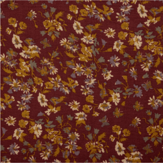 Floral patterned fabric with small flowers on a red-brown background