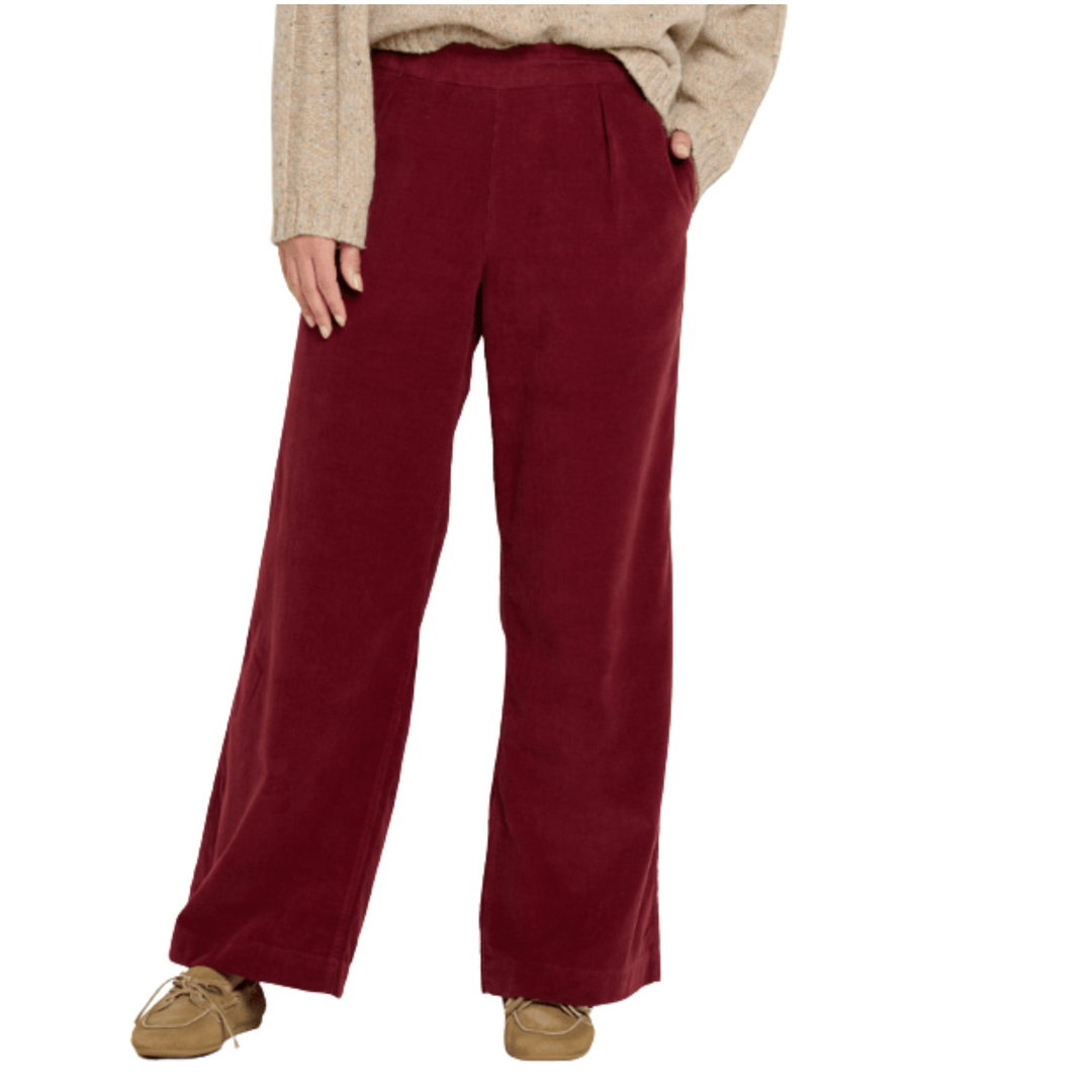 Maroon pants worn by a person on a white background