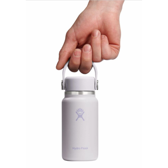 Hand holding a pink Hydro Flask water bottle on a white background