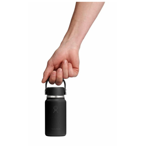 Black water bottle with a hand holding it on a white background