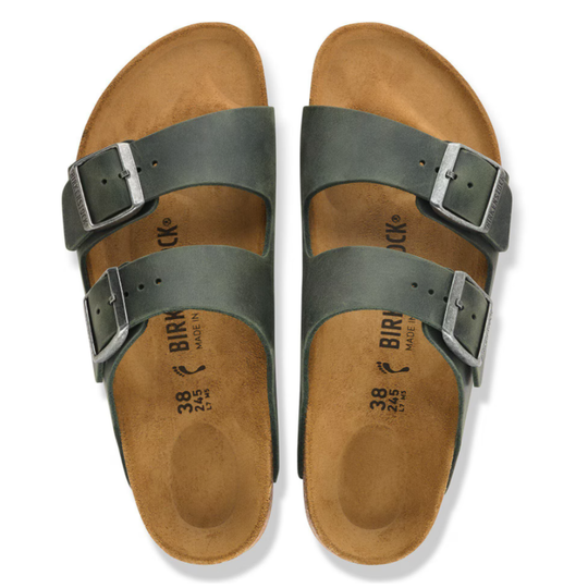 Pair of Birkenstock sandals with brown soles and green straps on a white background