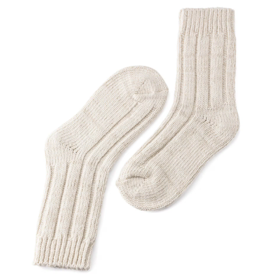 Pair of beige knitted socks on a white background