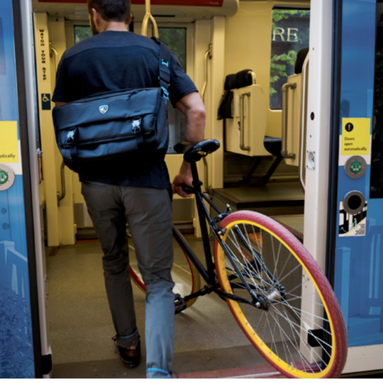 Person with a bicycle inside a train