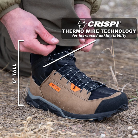 leather brown hiking boot with crispi orange logo on a dirt woods background. Writing on the image stating 6" tall 