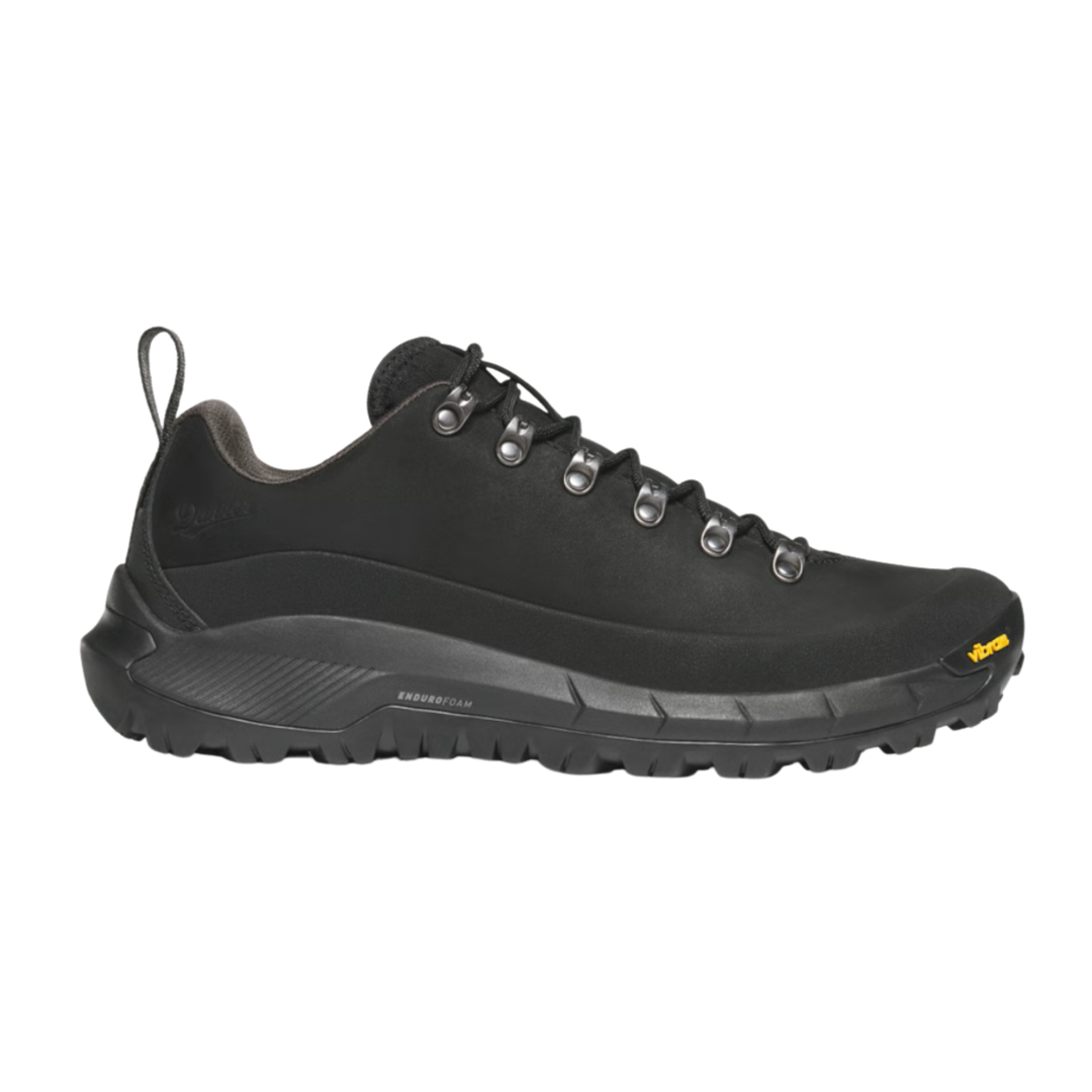 Black sneaker with textured sole on a white background