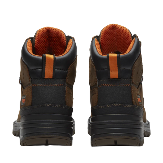 Pair of brown and black boots with orange accents on a white background