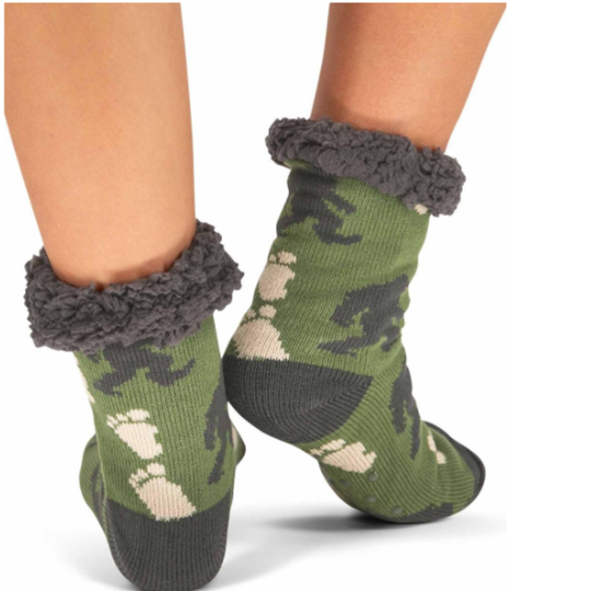 Dusty Turquois dinosaur-patterned socks with gray cuffs worn by a person on a white background