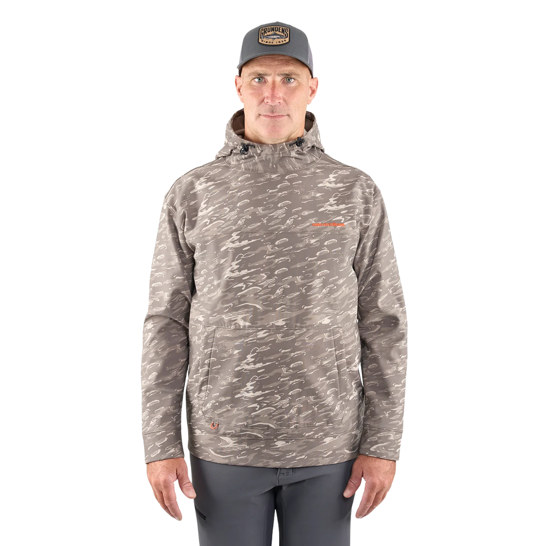 Man wearing a camouflage hoodie and cap on a white background