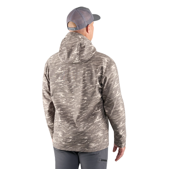 Person wearing a camouflage jacket and cap on a white background