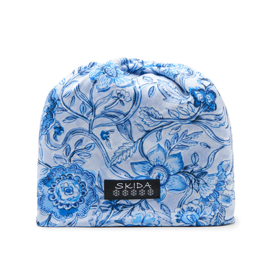 Blue floral patterned beanie with 'Skida' label on a white background