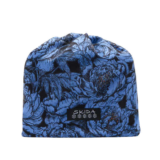 Blue floral-patterned beanie with 'Skida' logo on a white background