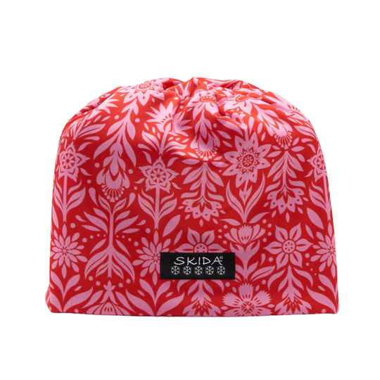 Red and white floral patterned drawstring bag with 'Skida' logo on a white background