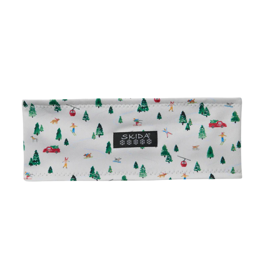 White and green trees wiht skiers on headband with Skida black label on white background