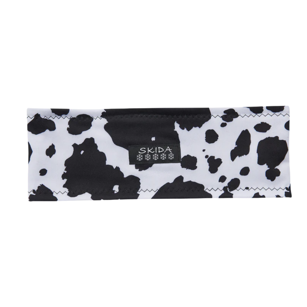 cow print headband with skida black logo on white background 