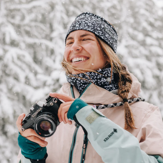 Skida Alpine Fleece Neckwarmer - Daisy Jones black and white flower print on Winter snow pine tree background 