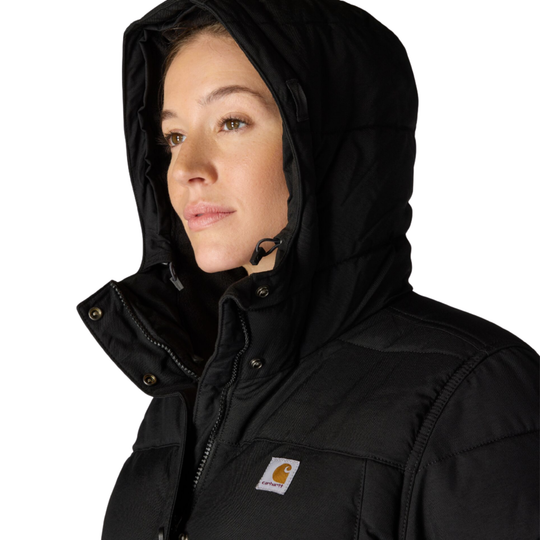 Close up of woman wearing black Carhartt parka with the hood up on a white background