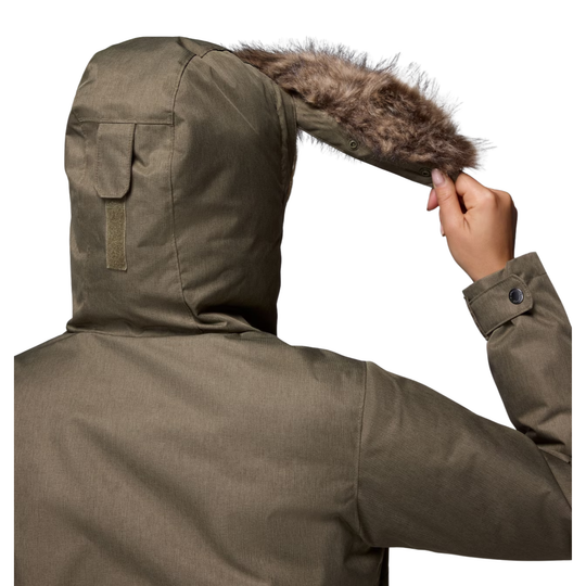 back of woman wearing Columbia Women's Suttle Mountain Long Insulated Jacket - Stone Green on white background and showing the fur on the hood is detachable 