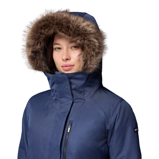fur lined hood up woman wearing Columbia Women's Suttle Mountain Long Insulated Jacket - Collegiate Navy on white background