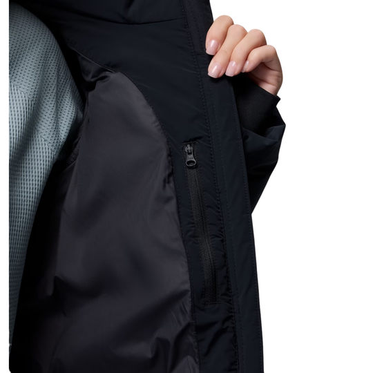 Woman wearing Columbia Women's Amaze Puff Mid Hooded Jacket - Black on white background. showing the interior of the jacket with zipper pocket