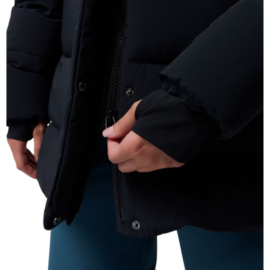 Woman wearing Columbia Women's Amaze Puff Mid Hooded Jacket - Black on white background. close up of bottom zipper going up and down.
