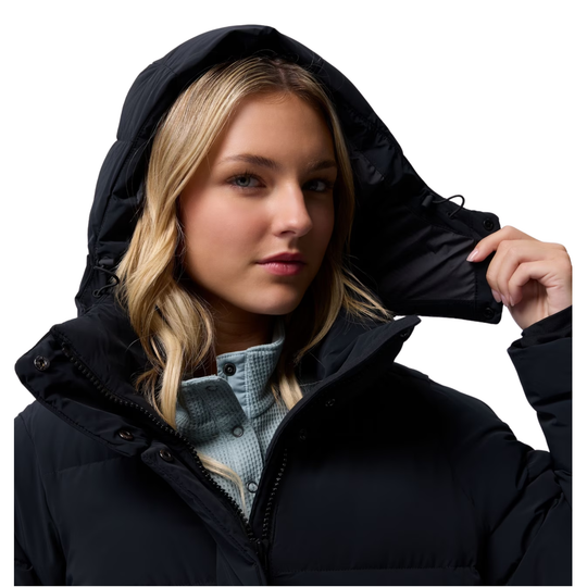 Woman wearing Columbia Women's Amaze Puff Mid Hooded Jacket - Black on white background. close up of her removing the removeable hood 