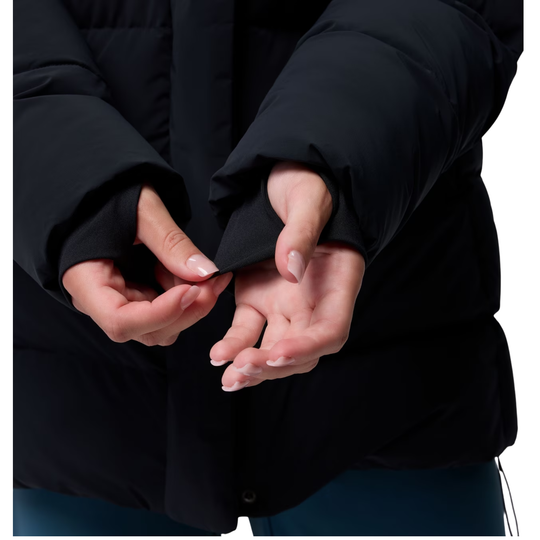 Woman wearing Columbia Women's Amaze Puff Mid Hooded Jacket - Black on white background. Close up of her extending the cuffs
