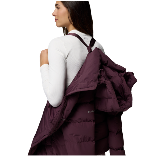 Woman wearing Columbia Women's Amaze Puff Mid Hooded Jacket - Moonvista on white background. jacket off shoulders being held by suspender like material