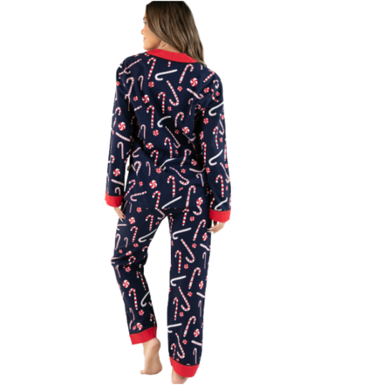 A woman shown from the back wearing a navy blue one-piece pajama set with a white and red candy cane pattern and red trim.