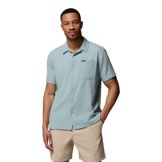 Man wearing Columbia Men's Utilizer Short Sleeve Camp Shirt - Crushed Blue on white background