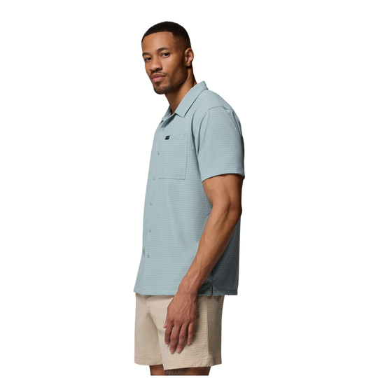 side view of Man wearing Columbia Men's Utilizer Short Sleeve Camp Shirt - Crushed Blue on white background