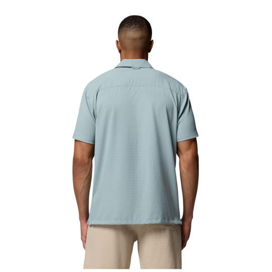 Back of Man wearing Columbia Men's Utilizer Short Sleeve Camp Shirt - Crushed Blue on white background