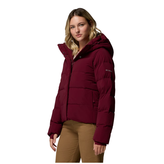 side view of Woman wearing Columbia Women's Amaze Puff Hooded Jacket - Rich Wine on a plain white background