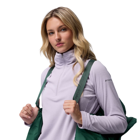 woman wearing Columbia Women's Amaze Puff Hooded Jacket - Rain Forest on plain white background. Showing off the suspender shoulder system to hook the jacket.