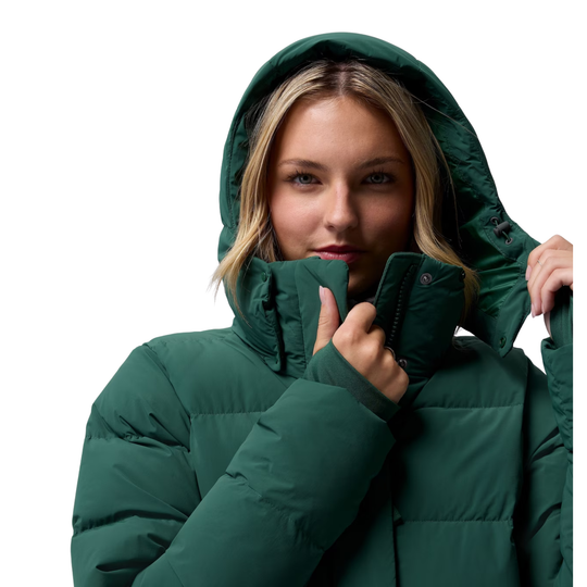 woman wearing Columbia Women's Amaze Puff Hooded Jacket - Rain Forest on plain white background. Having the hood up and showing the snappable buttons