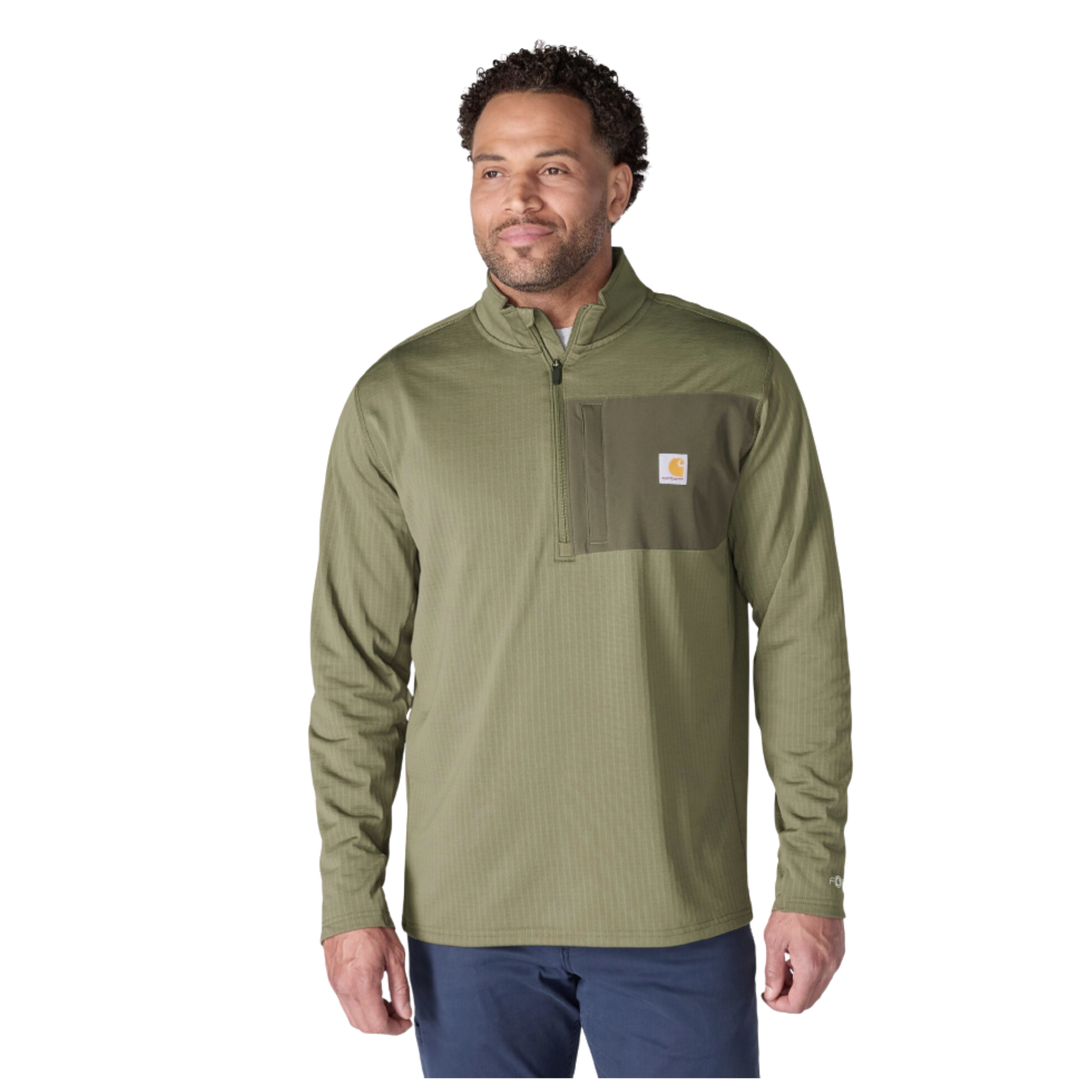 Man wearing Carhartt Men's Force Relaxed Fit Mock Neck Half Zip Fleece Lined Shirt - Dusty Olive on a plain white background