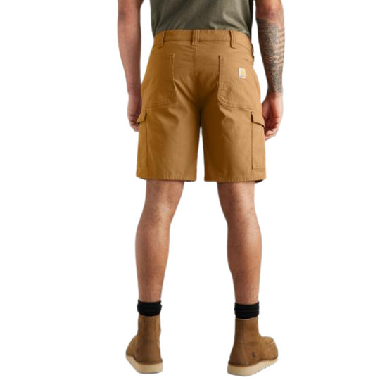 A man shown from the back wearing tan work shorts, a dark green t-shirt, black socks, and tan boots against a plain white background.