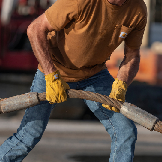 Man wearing Carhartt leather gloves. Holding a thick rope with the gloves