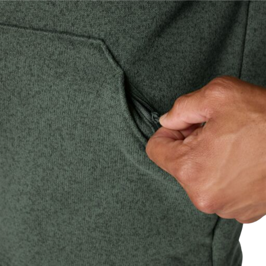 Close-up of a person's hand pulling a zipper on a dark green heathered zippered pouch pocket.