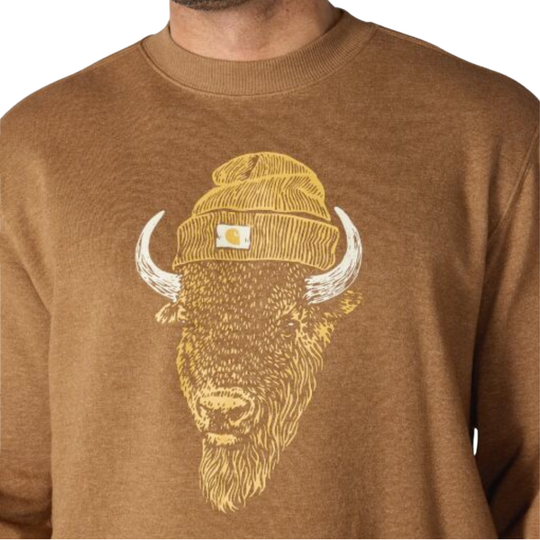 A close-up of a brown crewneck sweatshirt featuring a graphic of a bison wearing a yellow beanie with a small white square patch on the front.