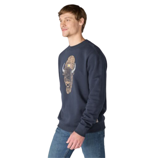 A man wearing a navy blue crewneck sweatshirt with a large embroidered bison graphic on the front, paired with blue jeans, shown against a plain white background.