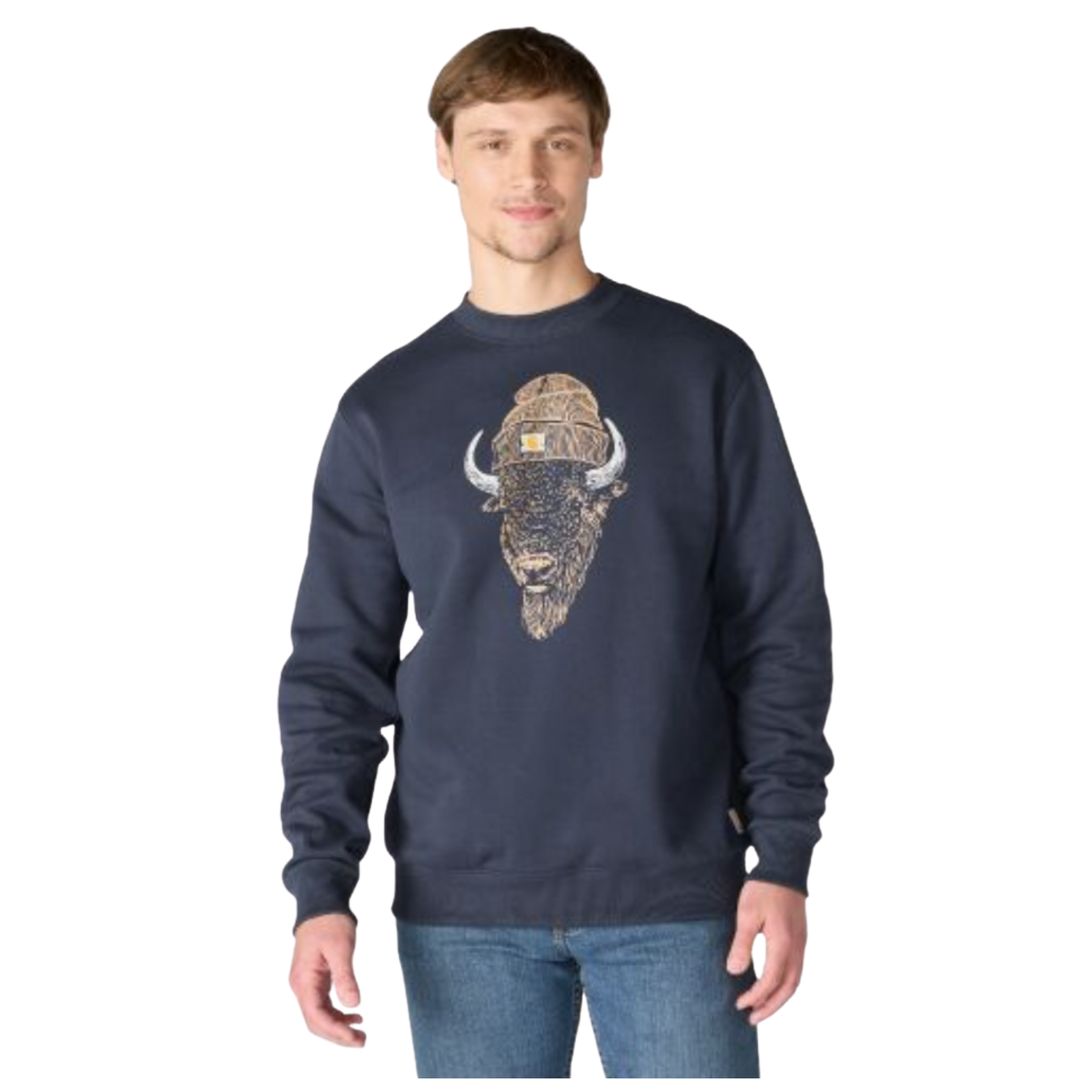 A man wearing a navy blue crewneck sweatshirt with a large graphic of a bison wearing a camouflage winter hat on the front, paired with blue jeans against a plain white background.