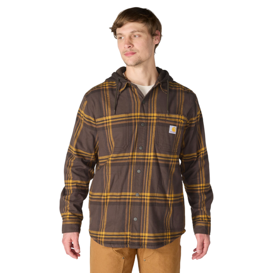 A man wearing a brown hooded button-up flannel shirt with a yellow plaid pattern and tan pants, photographed against a plain white background.