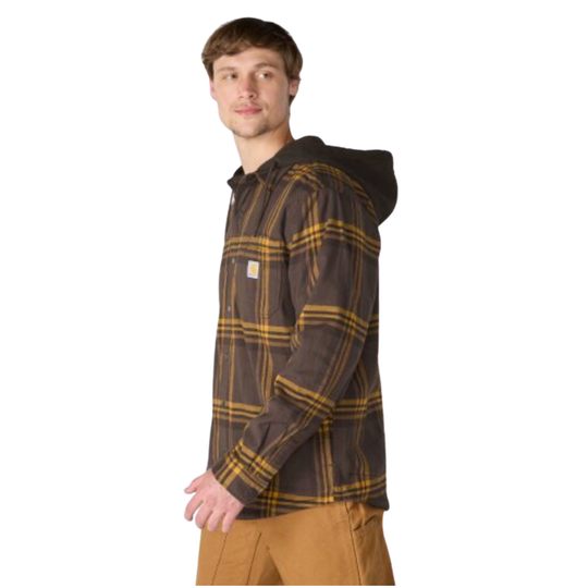 A man wearing a brown hooded flannel shirt jacket with a yellow and brown plaid pattern, paired with tan pants, shown against a plain white background.